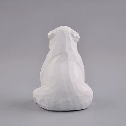 Back view of sitting polar bear wood carving