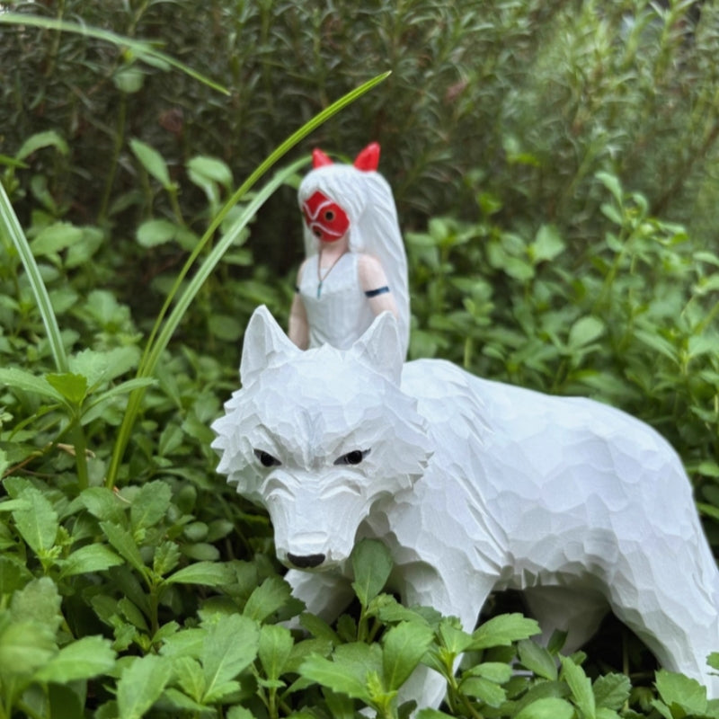 Princess Mononoke wooden figurine displayed outdoors among greenery