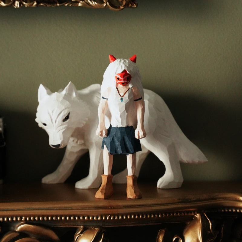 wooden Princess Mononoke figurine displayed on a shelf with white wolf
