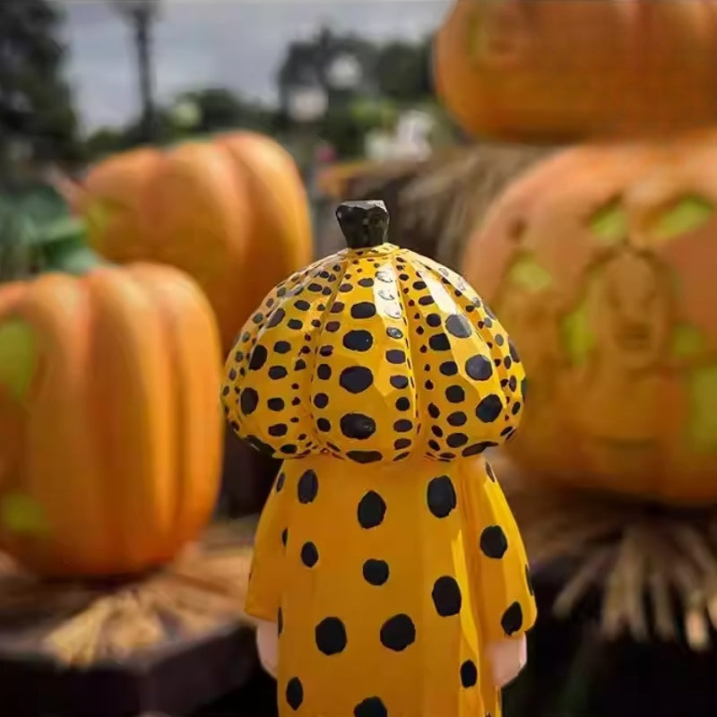 Yellow polka dot pumpkin head wooden figurine with pumpkins behind