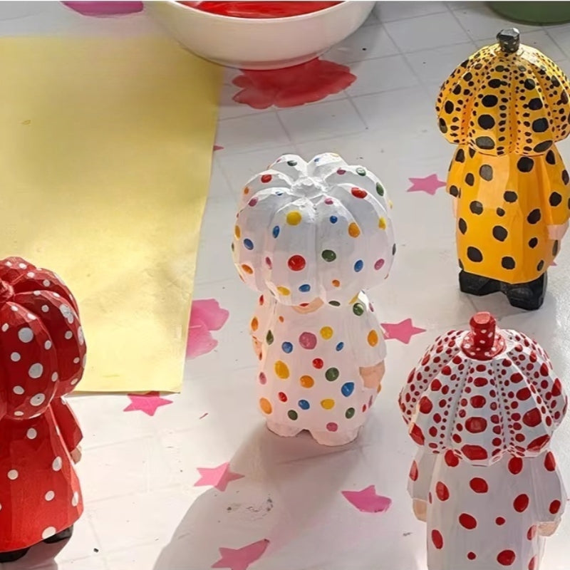 Polka dot pumpkin head wooden figurines in four color variations