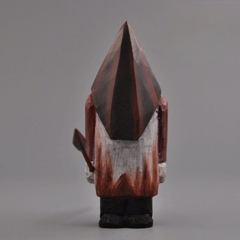 Full rear view of the wooden Pyramid Head statue against a neutral gray backdrop.