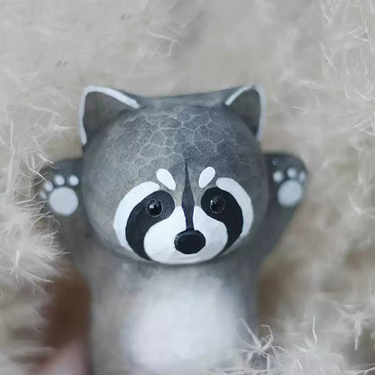 Close-up of raccoon figurine on soft fabric