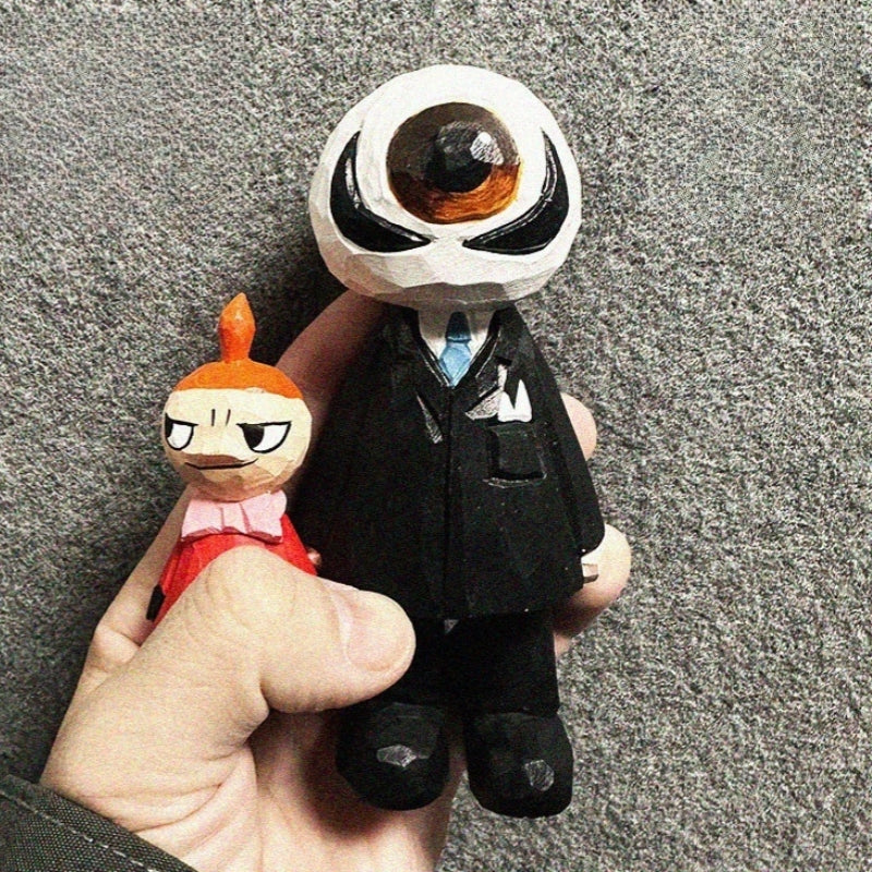 Hand carved wooden eyeball figure held in hand for size reference