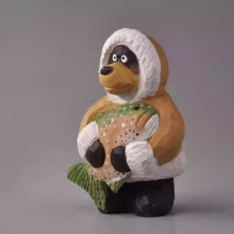 Rustic wooden bear figurine holding fish upright
