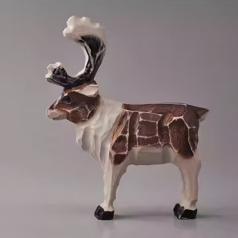 Rustic reindeer figurine with worn paint edges and visible carved planes