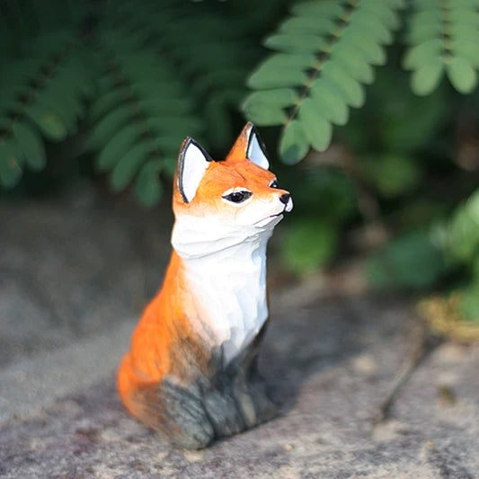 Sitting red fox figurine in fern setting