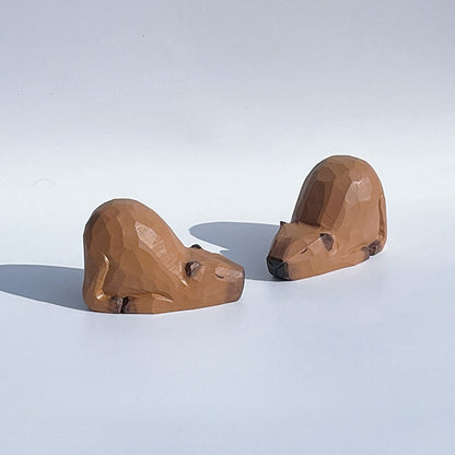 Rear side view of two capybara figurines