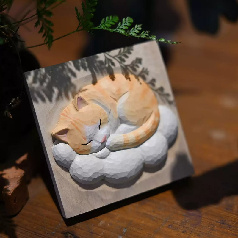 Sleeping cat wood carving with fern shadow