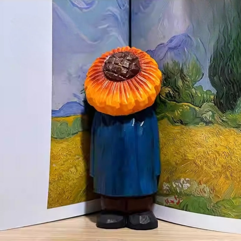 Sunflower man figure placed against an open book featuring Van Gogh’s sunflower painting.