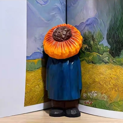Sunflower man figure placed against an open book featuring Van Gogh’s sunflower painting.