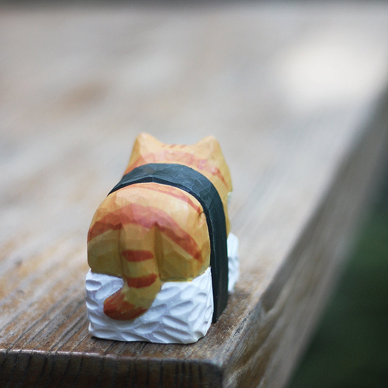 Sushi sleeping cat wooden figure, placed on the table