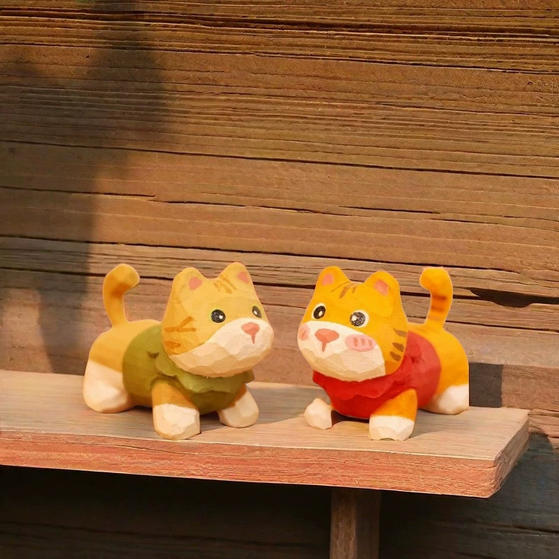 Orange and yellow tabby kitten figurines in sweaters