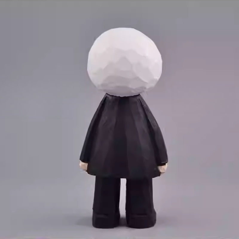 Back view of the Eyeball Figure revealing the textured surface of its white head and black coat.
