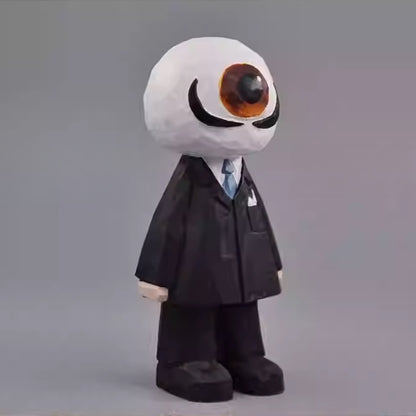 Angled view of the wooden Eyeball Figure highlighting the sculpted details of the suit and large eye.