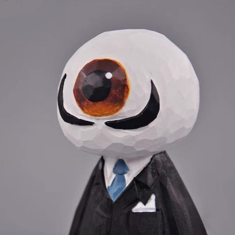 Detailed angled close-up of the Eyeball Figure’s head, showing the hand-painted eye and suit collar.