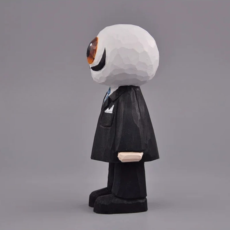 Side view of the eyeball figure with a rounded white head, black suit, and broad black shoes