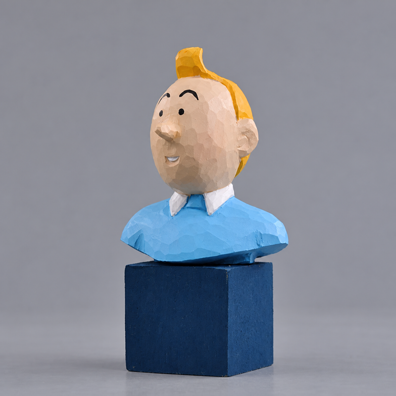 Tintin bust carved in wood with yellow hair and a blue sweater on a dark blue display stand