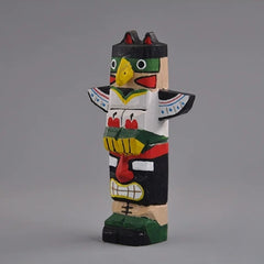 Front view of stacked totem pole figures hand-painted in color