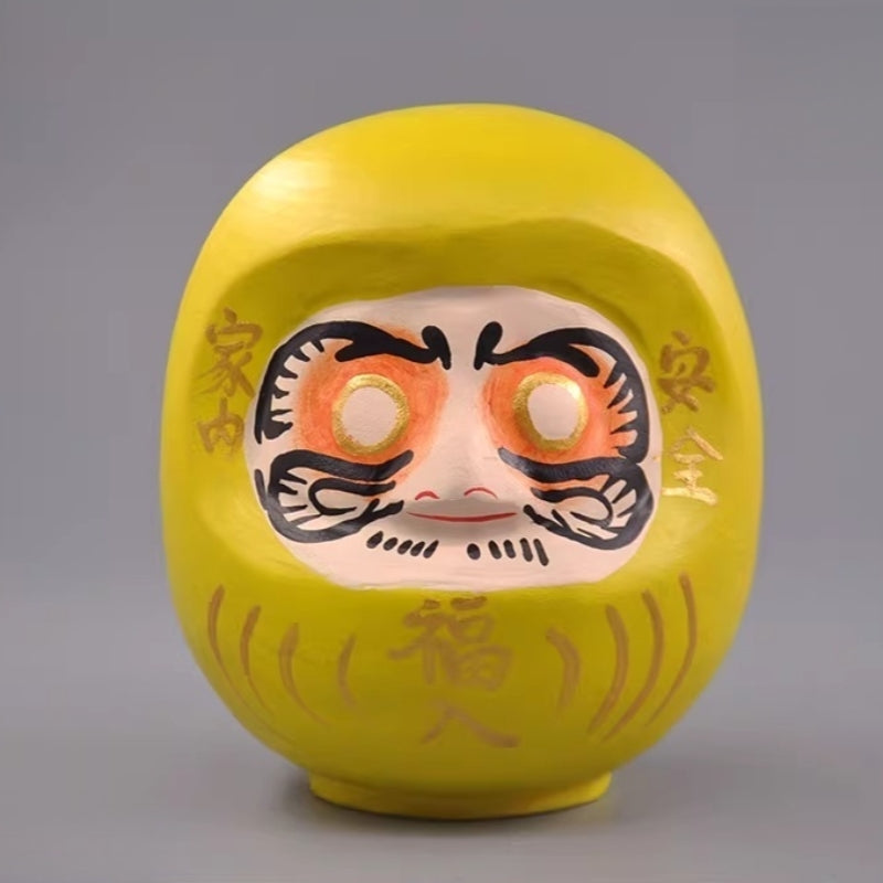Yellow Japanese daruma doll wooden figurine