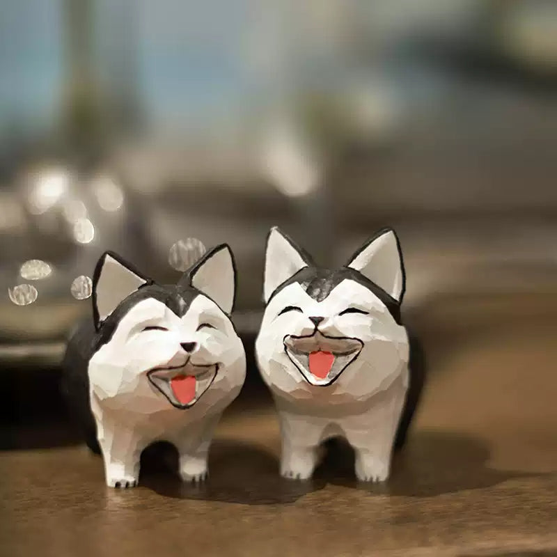 Two laughing husky figurines standing together with open-mouth smiles