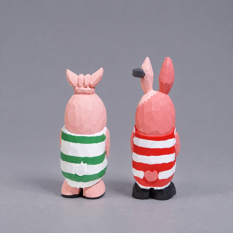 Back view of Putin and Kirenenko wooden figures showing striped outfits and small tails