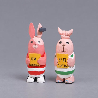 Kirenenko and Putin wooden Usavich figures holding yellow signs, front view