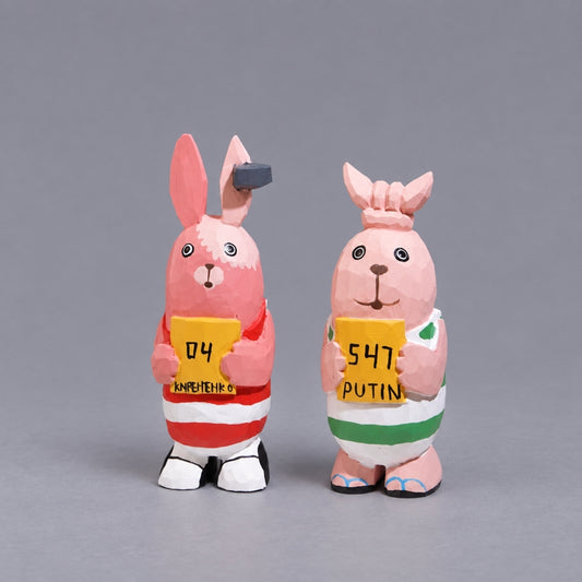 Kirenenko and Putin wooden Usavich figures holding yellow signs, front view