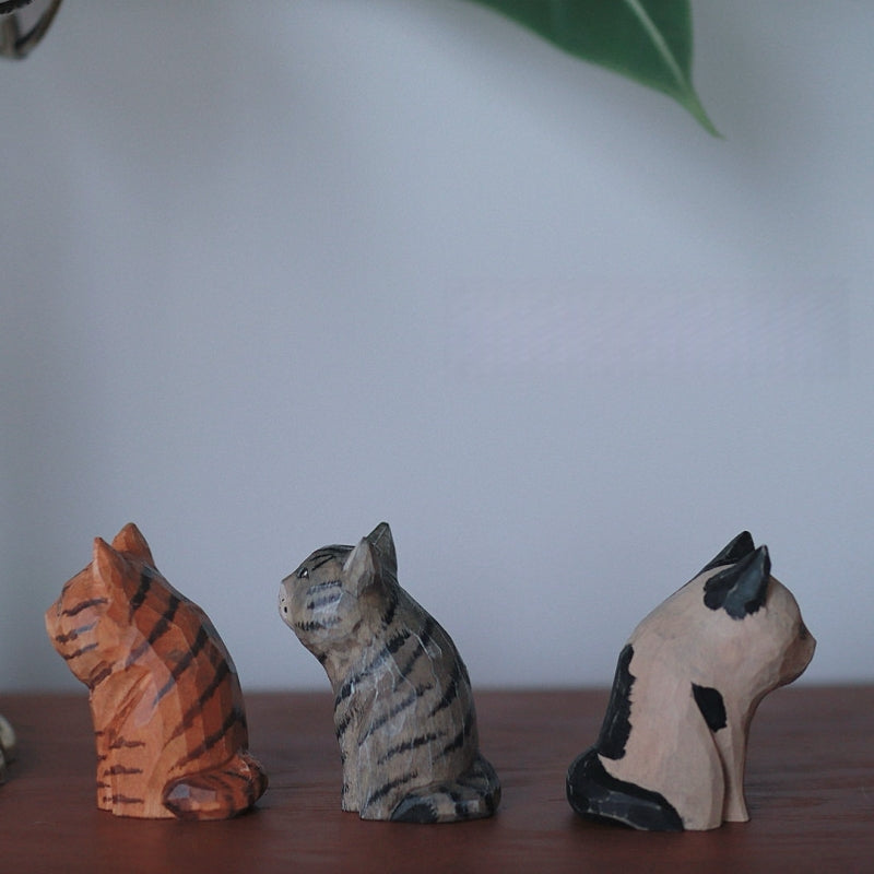 Side view of vintage cat wooden figurine set