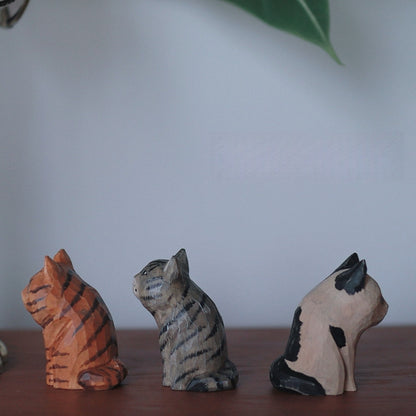 Side view of vintage cat wooden figurine set