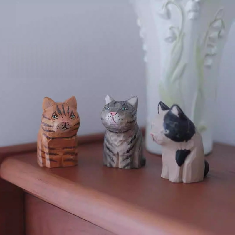 Vintage cat wooden figurines on shelf