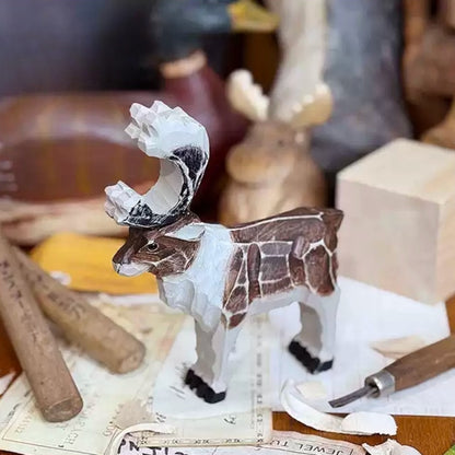 Wooden reindeer carving with a vintage finish beside carving tools and a wood block