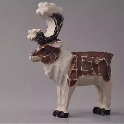 Hand-carved vintage reindeer figurine with large antlers and a distressed brown-and-white finish
