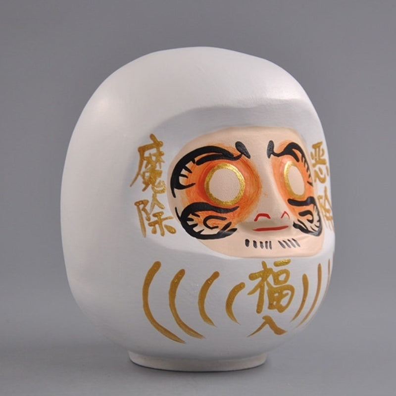 Side view of white wooden daruma doll
