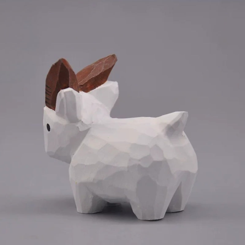 White goat figurine showing its carved body and raised tail