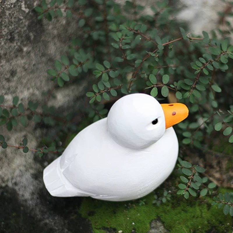 White wooden Call Duck viewed from above among green leaves