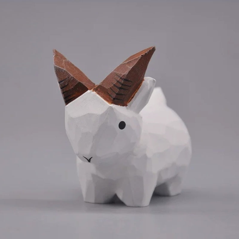 White wooden goat figurine in a front three-quarter view