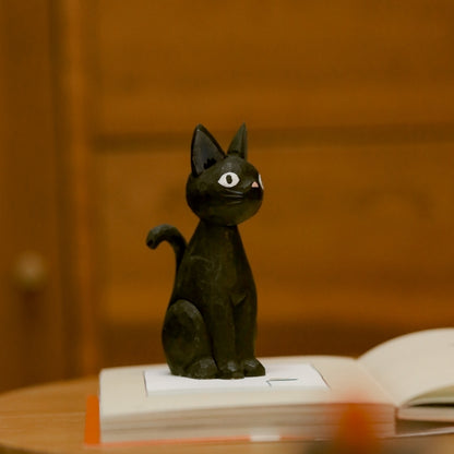 Wooden black cat figurine standing upright