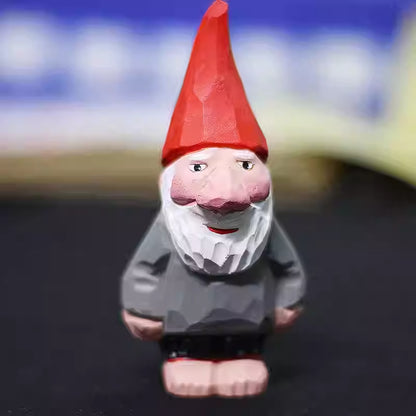 Hand-carved wooden gnome figurine with a tall red hat, large nose, and white beard