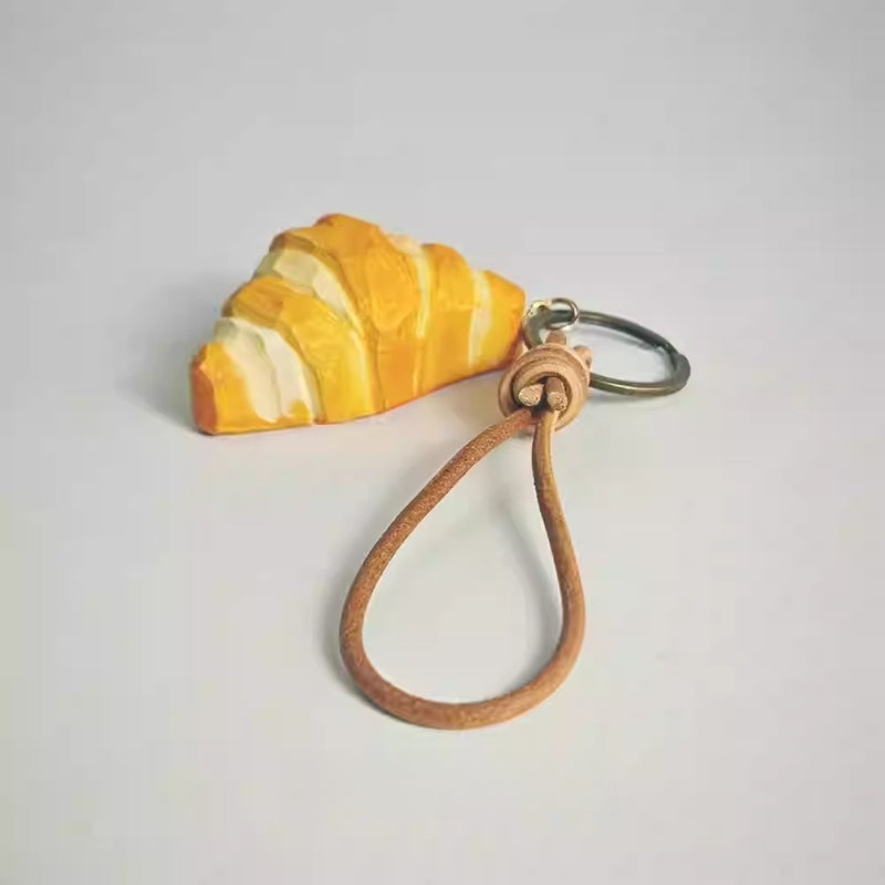 Handmade wooden croissant keychain detail