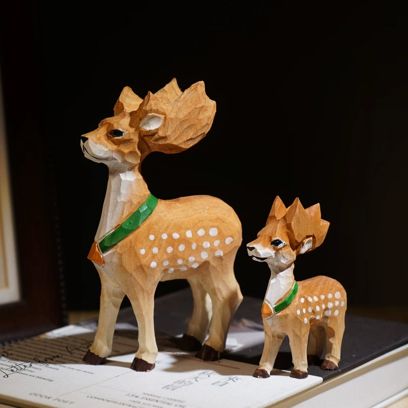 Hand-carved wooden deer figurines in small and large sizes with green scarves