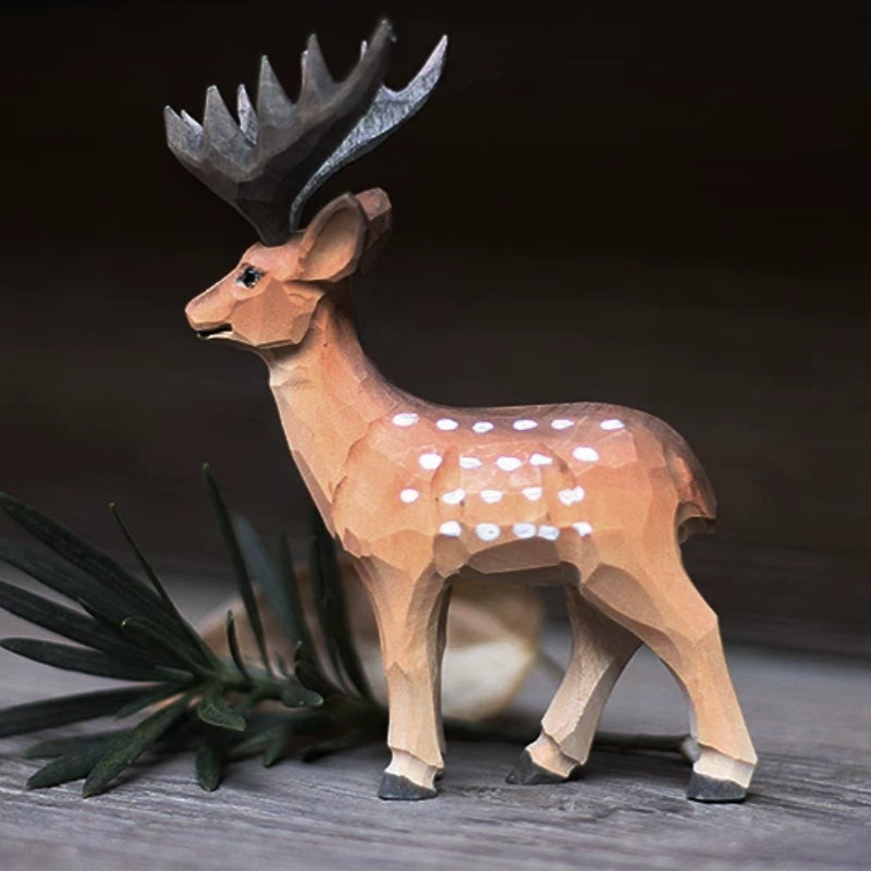 Male wooden deer figurine in side view, with broad dark antlers and white spots