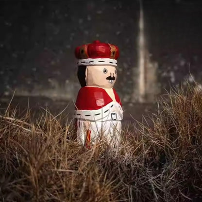 wooden nutcracker figurine placed in grass outdoor setting