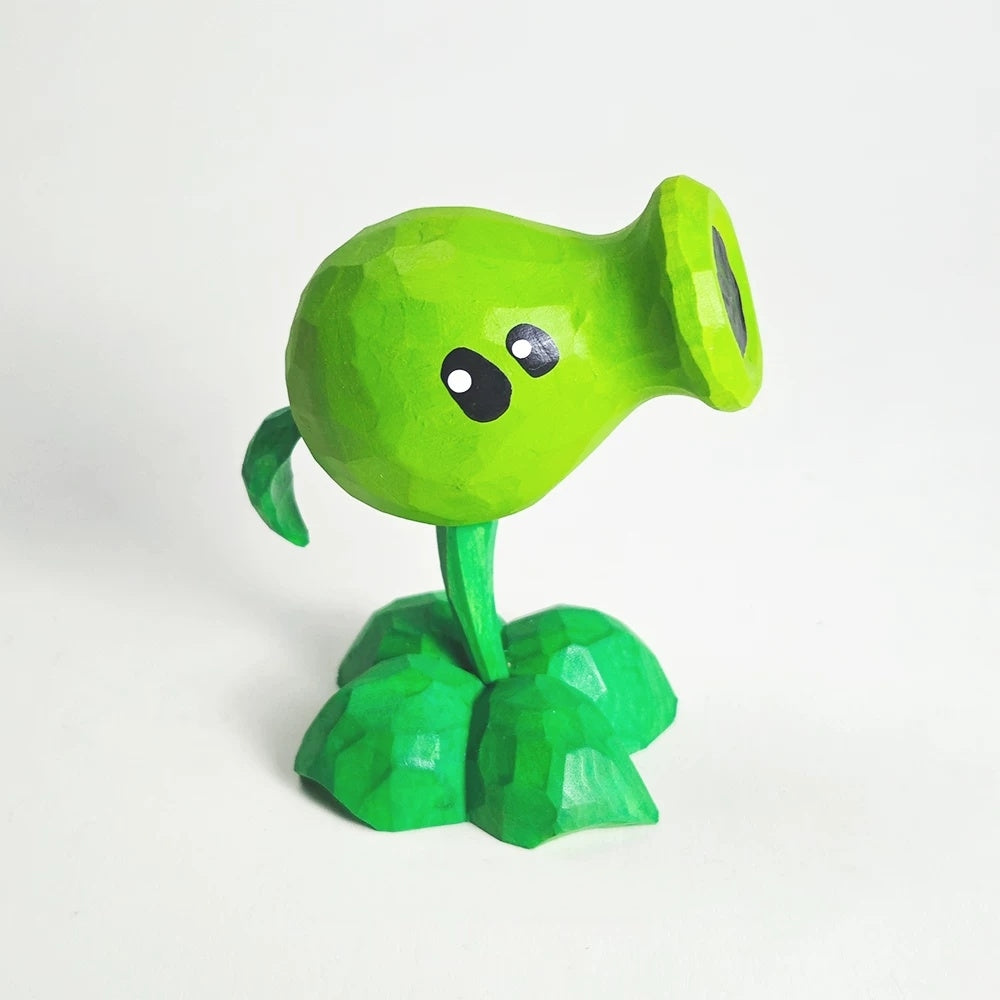 Hand-carved wooden Peashooter figure with both eyes visible and its mouth pointing right