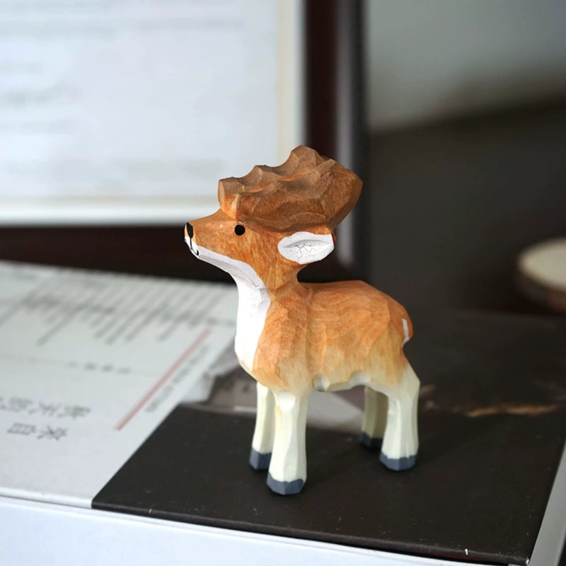 Side view of a single brown-and-white wooden reindeer figurine