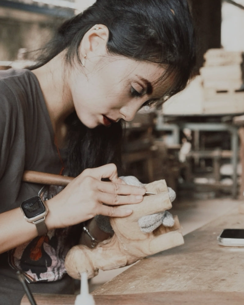 A wood carver from the Wooden Smile studio