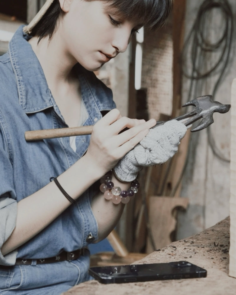 A wood carver from the Wooden Smile studio