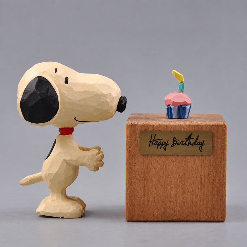 Wooden Snoopy standing beside a separate Happy Birthday display block with the removable cupcake on top
