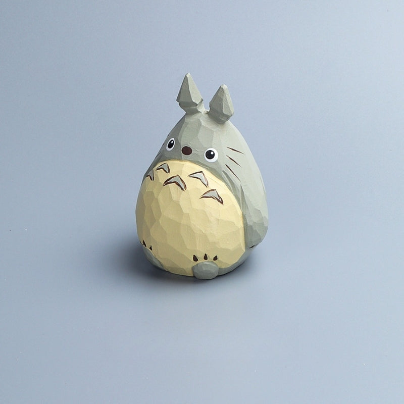 Single Totoro wood carving facing forward, featuring a chubby belly and painted expressions.