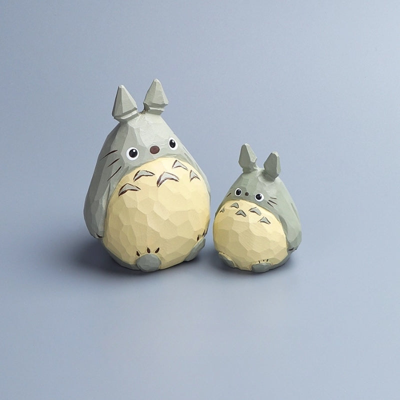 Two wooden Totoro carvings, large and small, shown from the front with detailed painting.